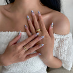 Model wearing Glamade luxury press-on nails, almond shape