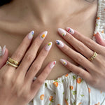 Model wearing Glamade luxury press-on nails, short almond shape