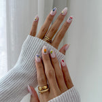 Model wearing Glamade luxury press-on nails, short almond shape