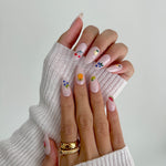 Model wearing Glamade luxury press-on nails, almond shape