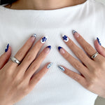 Model wearing Glamade luxury press-on nails, short almond shape