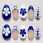 Set of nail art designs with blue and white floral patterns on a white background