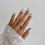 Model wearing Glamade luxury press-on nails, short almond shape