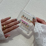 Model wearing Glamade luxury press-on nails, short almond shape